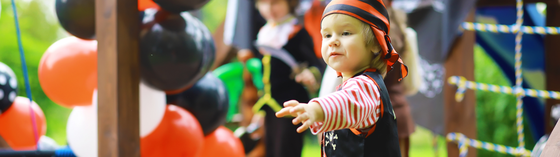 A baby pirate with a hook reaches for something
